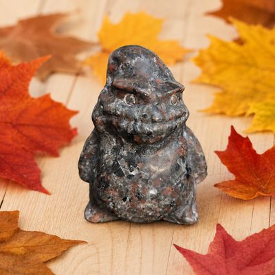 Yooperlite Oogie Boogie carving displayed on a light wooden table with fall leaves