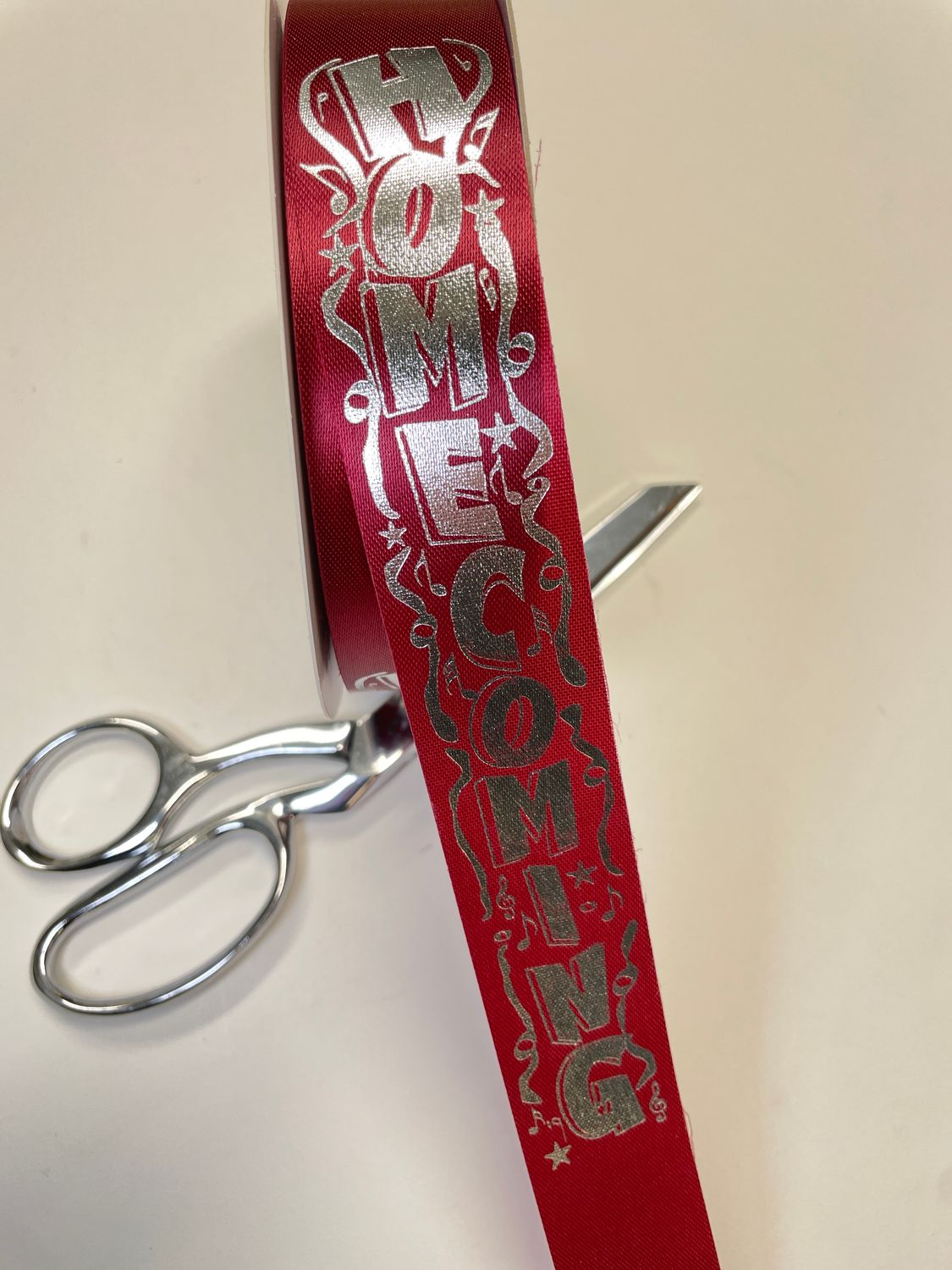 Pre-printed Silver HOMECOMING on burgundy Acetate ribbon- size 9