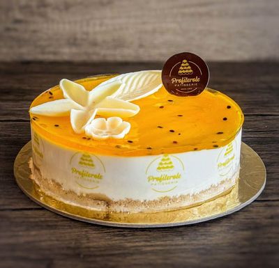 a passionfruit cheesecake with passionfruit pulp and chocolate ganache on top