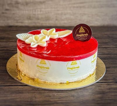 a strawberry cheesecake with strawberry jam and chocolate ganache on top