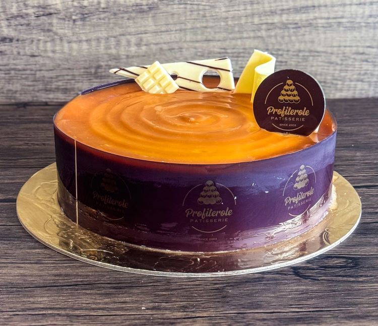 a caramel mousse cake with chocolate ganache on top