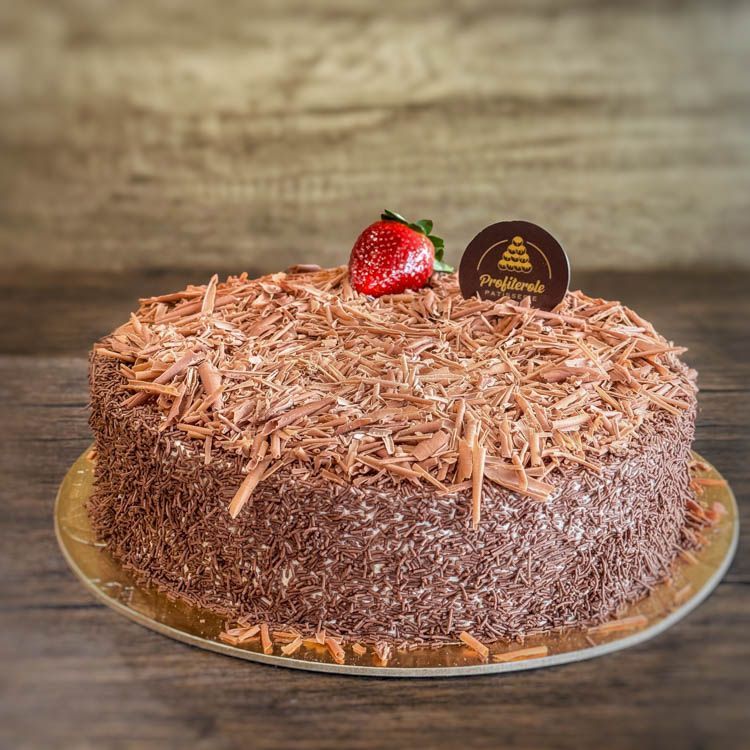 a black forest cake covered in chocolate sprinklers and chocolate finishing
