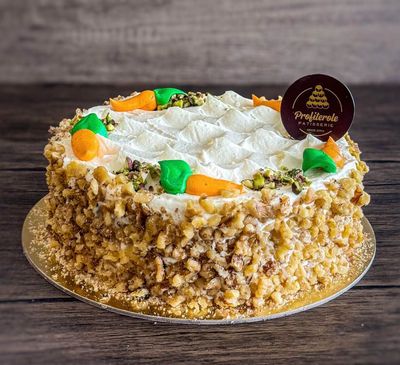 a carrot cake with walnuts arround and sultana on top