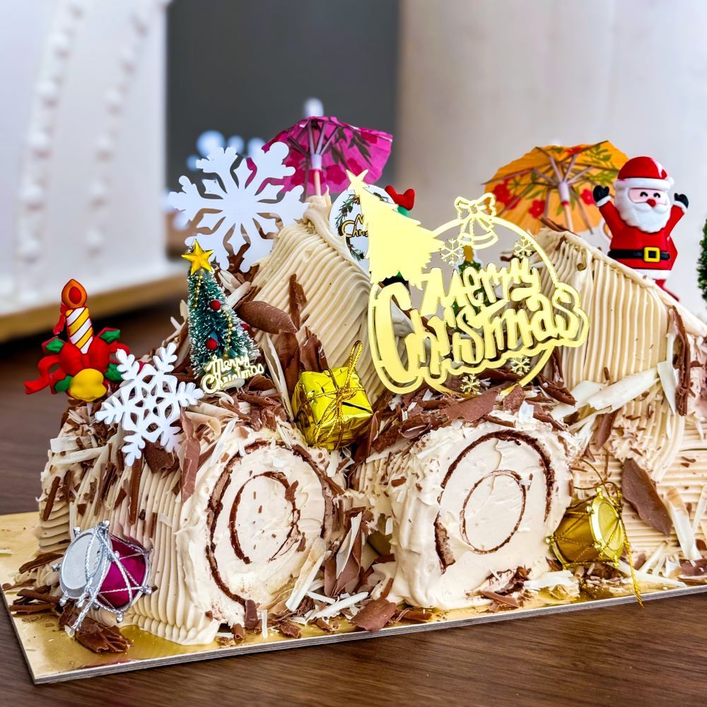 Christmas Log Cake -  Hazelnut Praline with various xmas figure decorations