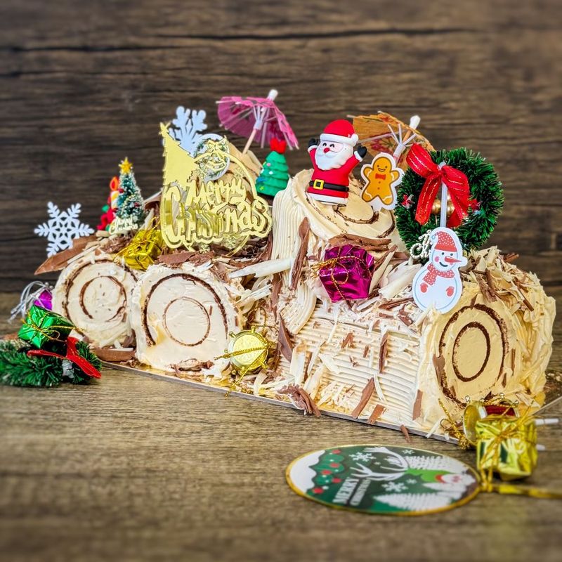 Christmas Log Cake -  Hazelnut Praline with various xmas figure decorations
