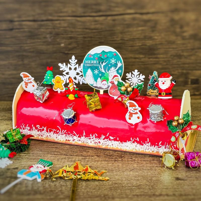 Christmas Log Cake - Ice Cream with ice cream filling and chocolate ganaches decorations, topping with various xmas figure decorations