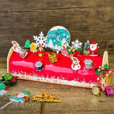 Christmas Log Cake - Ice Cream with ice cream filling and chocolate ganaches decorations, topping with various xmas figure decorations