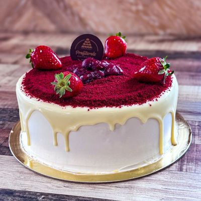 A red velvet cake with fresh strawberries on top