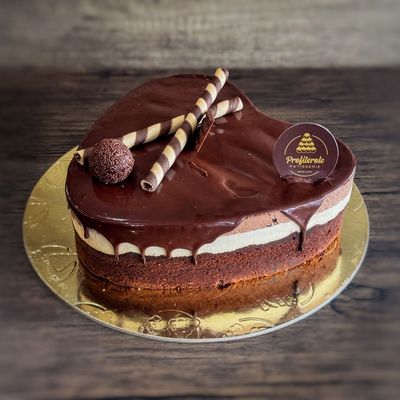 a profiterole chocolate trio cake with a heart shape