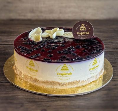 a blueberry cheesecake with blueberry dressing and chocolate ganache on top