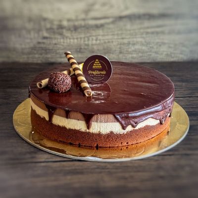 A profiterole chocolate trio cake with round shape