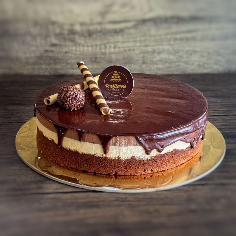A profiterole chocolate trio cake with round shape