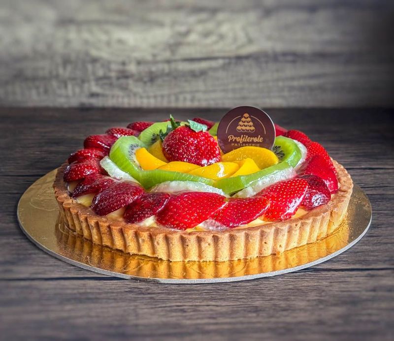 a round fruit cake with mixed fruits on top
