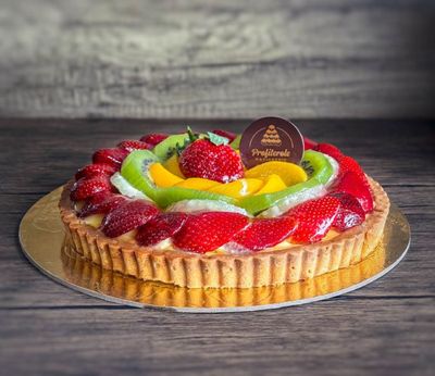 a round fruit cake with mixed fruits on top