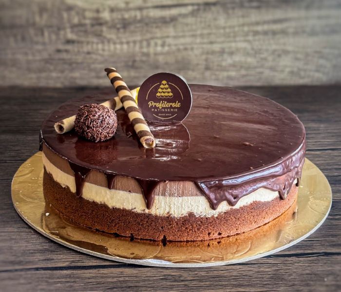 A profiterole chocolate trio cake with round shape