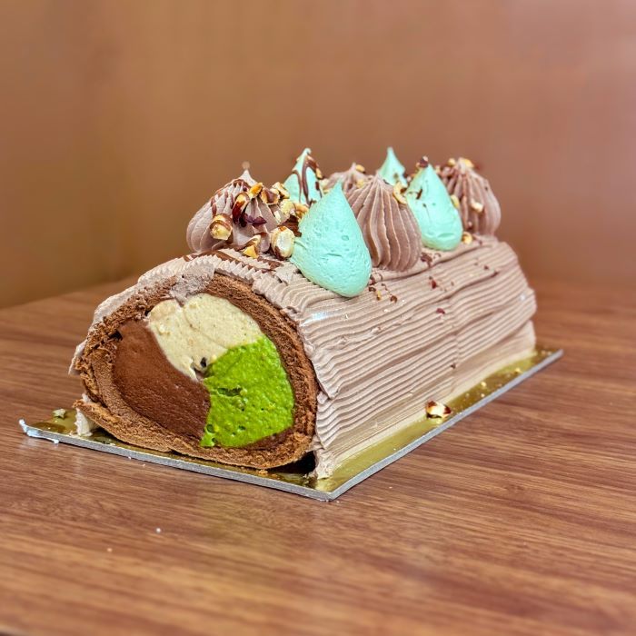 chocolate swiss roll ice cream cake with chocolate, hazelnut and pistachio gelato