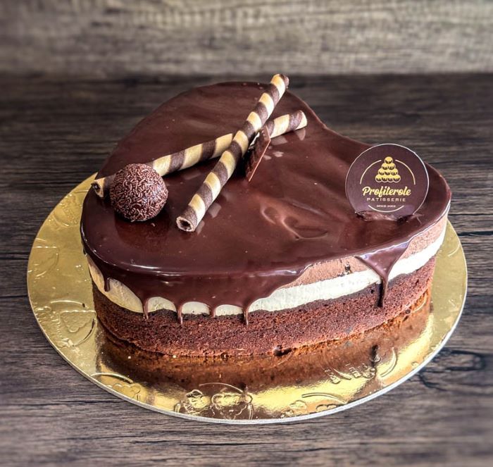 a profiterole chocolate trio cake with a heart shape