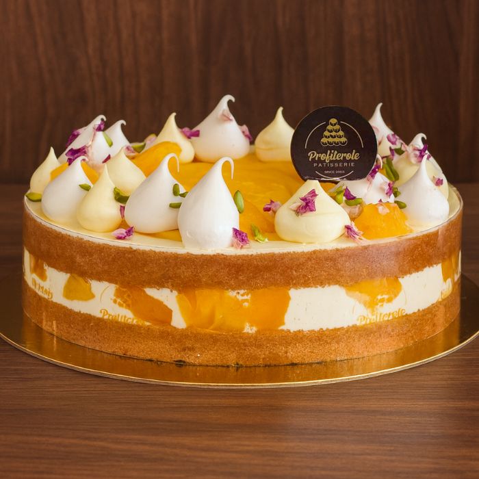 a mango cake with fresh mango pieces & fresh cream