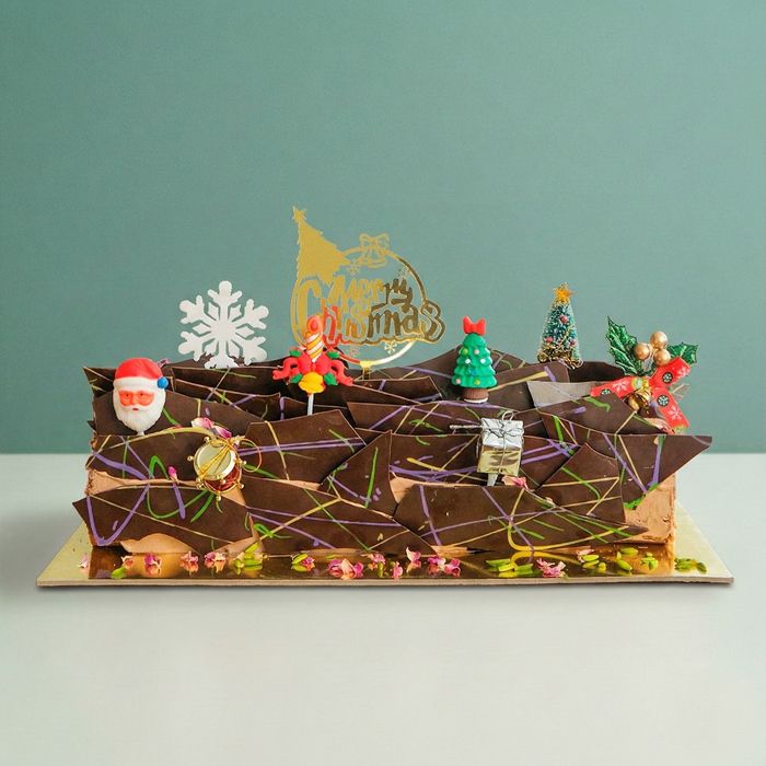 Dubai Christmas Chocolate Log Cake a dubai chocolate christmas log with christmas decorations