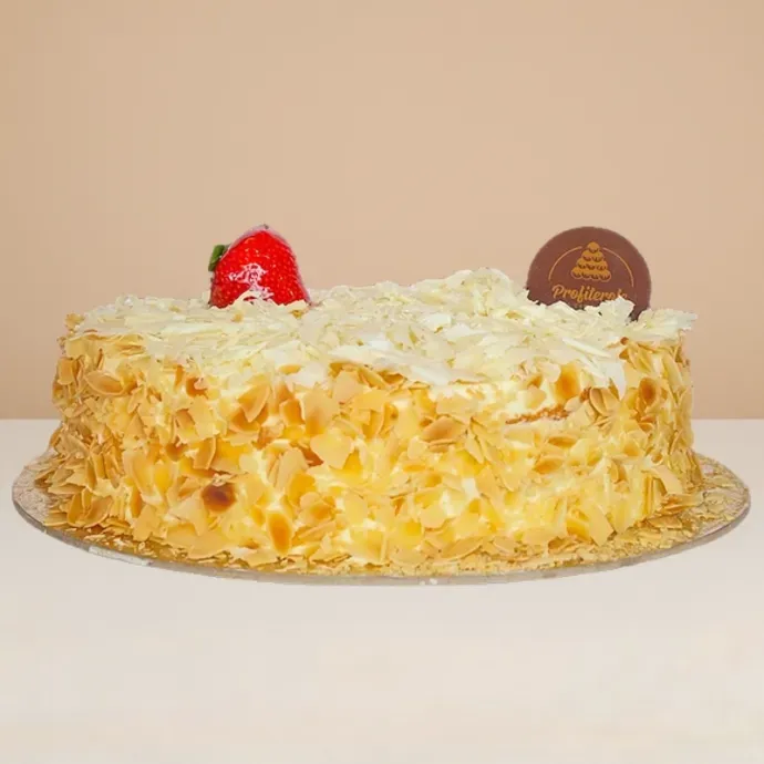 side view of the white forest cake showing the good contrast of llmond flakes on the side and white chocolate shavings