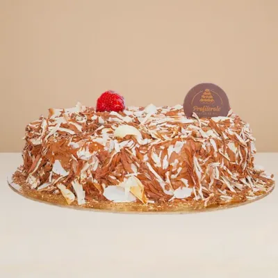 side view of chocolate custard cake covered in chocolate finishings