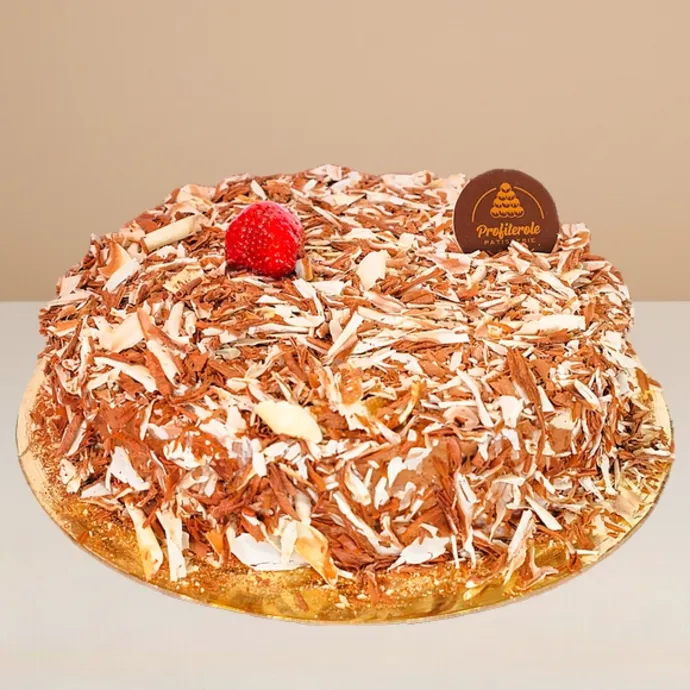 side view of chocolate custard cake covered in chocolate finishings