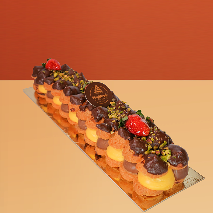 Profiterole log cake with chocolate & vanilla custard profiteroles, pistachios & fresh strawberry by Profiterole Patisserie
