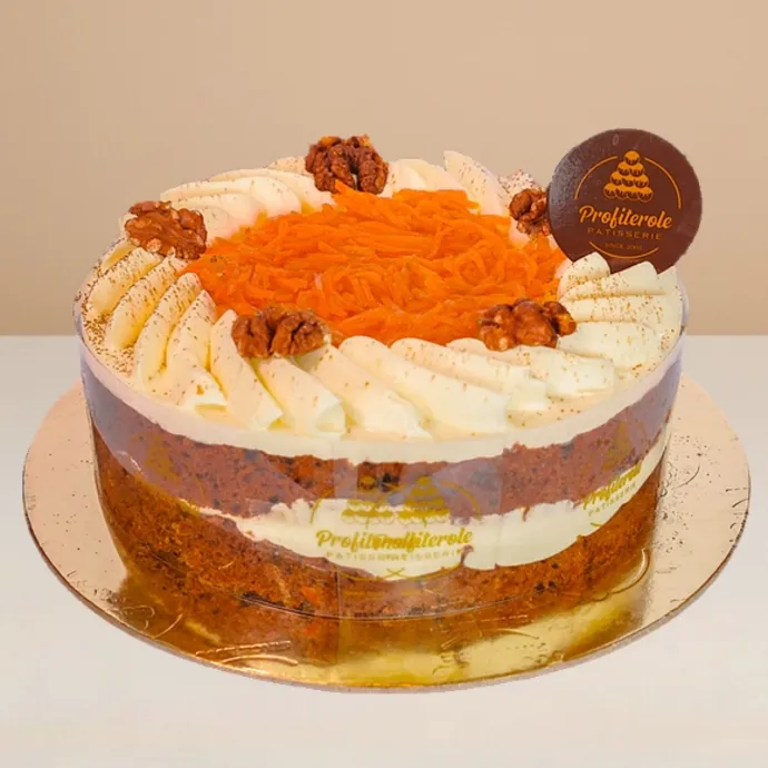 side view of carrot cake with cream cheese topping, walnuts and sultanas
