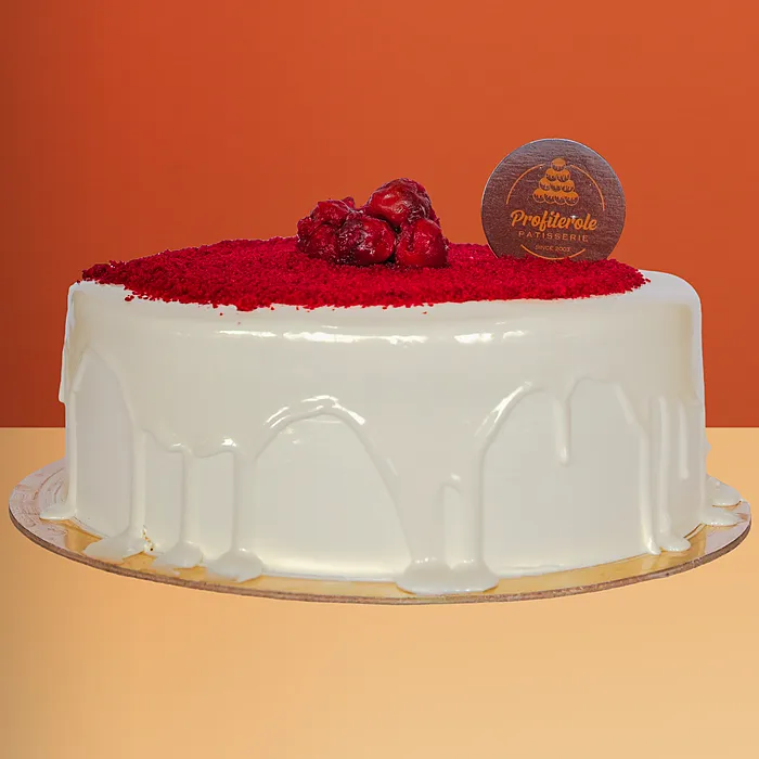 Red Velvet Cake Red velvet cake with cream cheese frosting, white chocolate drip, crumbs & strawberries by Profiterole Patisserie