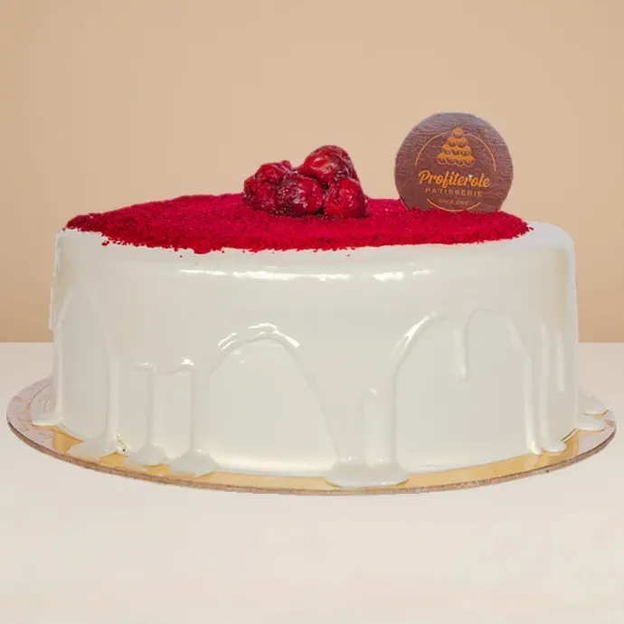 side view of the red velvet cake showing the glossy cream cheese covering 