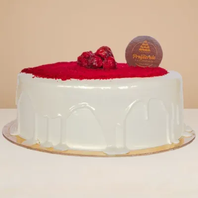 side view of the red velvet cake showing the glossy cream cheese covering 