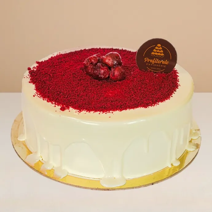 side view of the red velvet cake showing the glossy cream cheese covering 