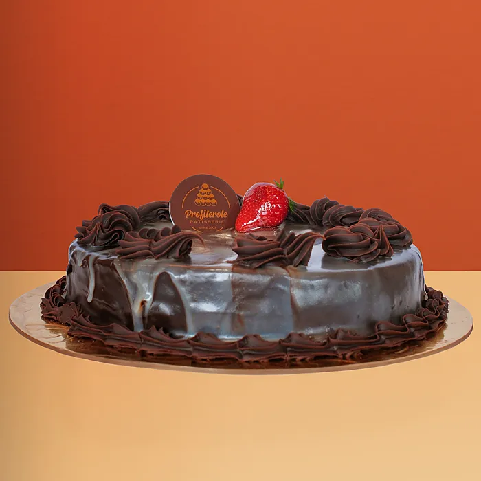 Chocolate marble mud cake with piped dark and milk chocolate swirl dollops on a glossy ganache base by Profiterole Patisserie