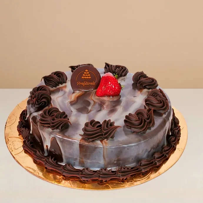 side view of marble mud cake topped with chocolate and strawberry
