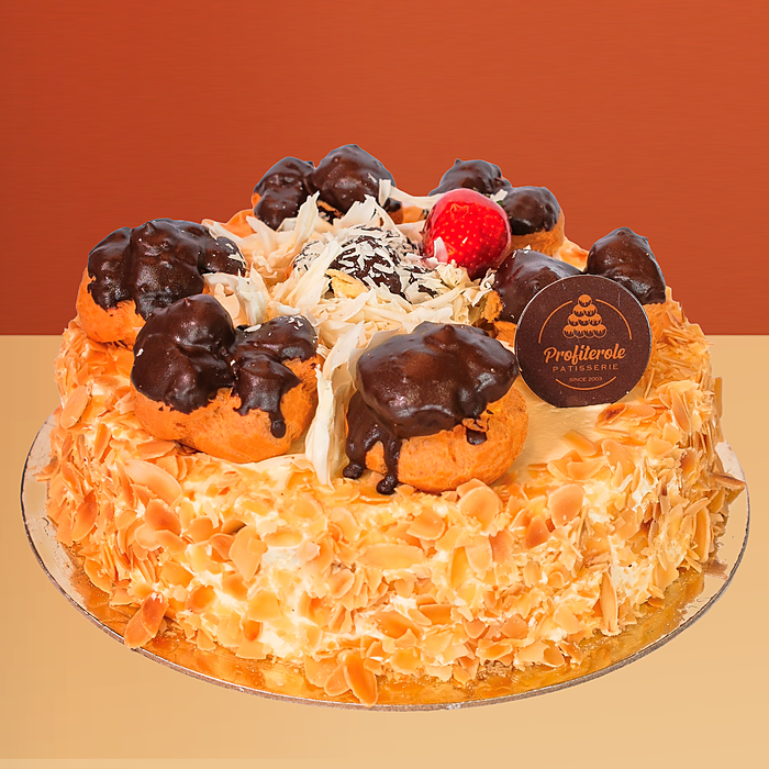 White profiterole cake with toasted almond sides and chocolate-dipped cream profiteroles by Profiterole Patisserie
