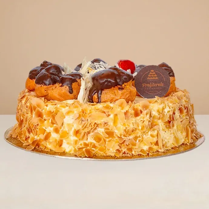 side view of the white profiterole cake showing the white forest cake base and profiteroles