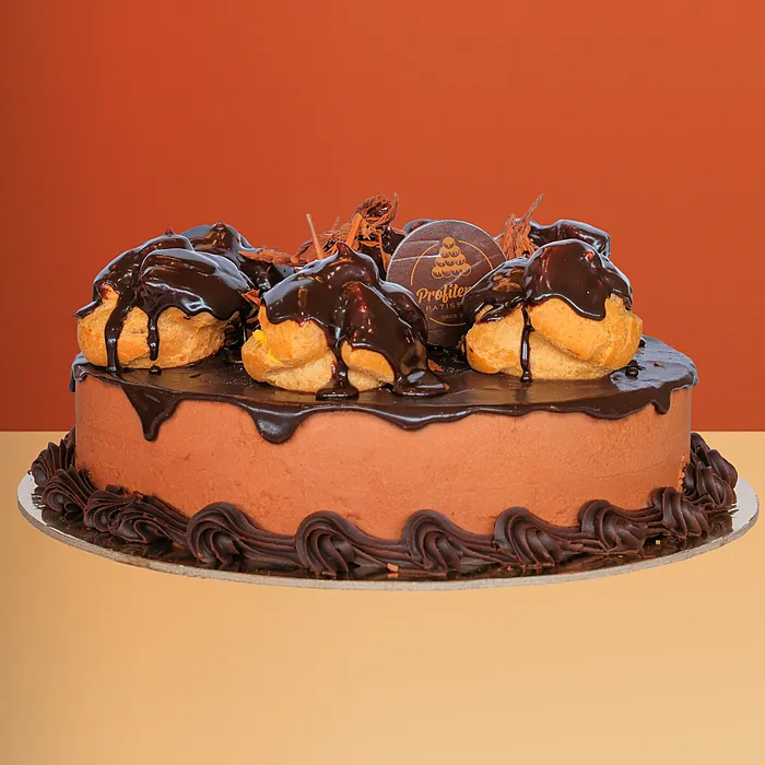Mousse Profiterole Cake Chocolate mousse profiterole cake topped with profiteroles, chocolate ganache & piped chocolate border by Profiterole
