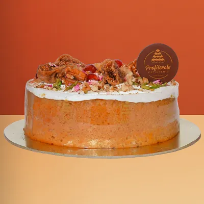 Dairy free cake with a semi-naked finish topped with dried figs walnuts rose petals and pistachios by Profiterole Patisserie