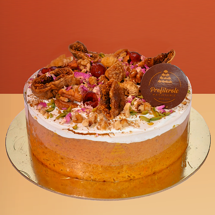 Dairy free cake with a semi-naked finish topped with dried figs walnuts rose petals and pistachios by Profiterole Patisserie
