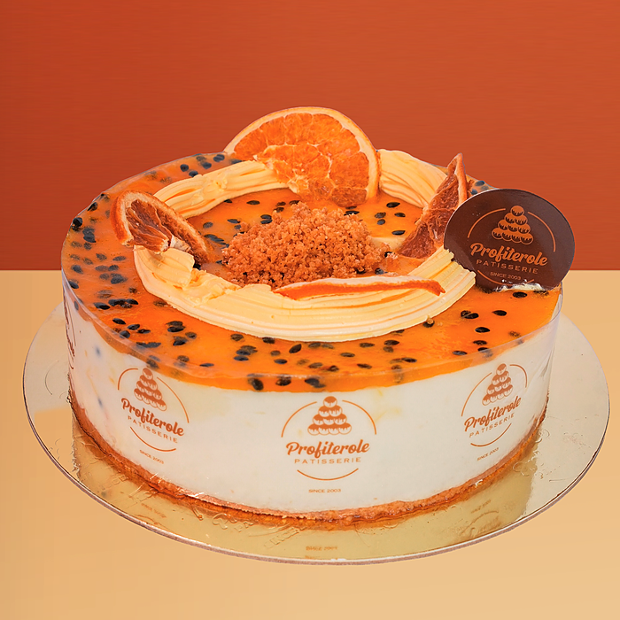 Passionfruit cheesecake with glaze, orange slices & pulp on a creamy base by Profiterole Patisserie