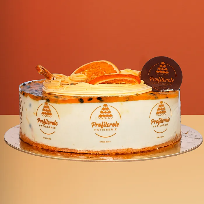 Passionfruit Cheesecake Passionfruit cheesecake with glaze, orange slices & pulp on a creamy base by Profiterole Patisserie