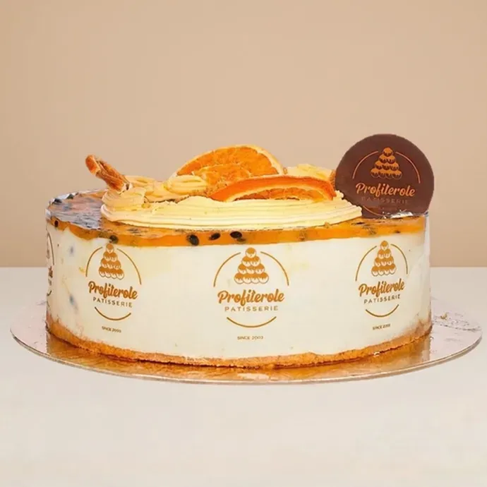 side view of the passionfruit cheesecake showing the thin bisuit crumble base thick layer of cream cheese