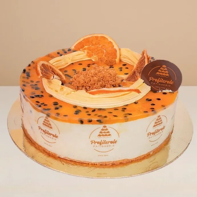 side view of the passionfruit cheesecake showing the thin bisuit crumble base thick layer of cream cheese