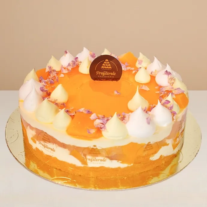 side view of the mango cake showing the alternating cream and fresh mango layers