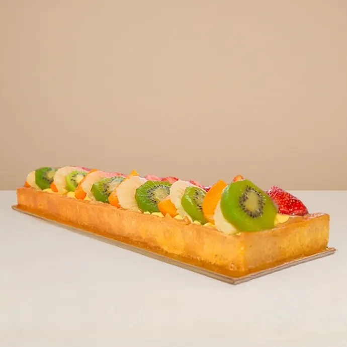 side view of fruit cake log showing clear details of the slices of fruit toppings