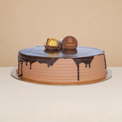 side view of the ferrero rocher cake with the chocolate ganache dripping downwards