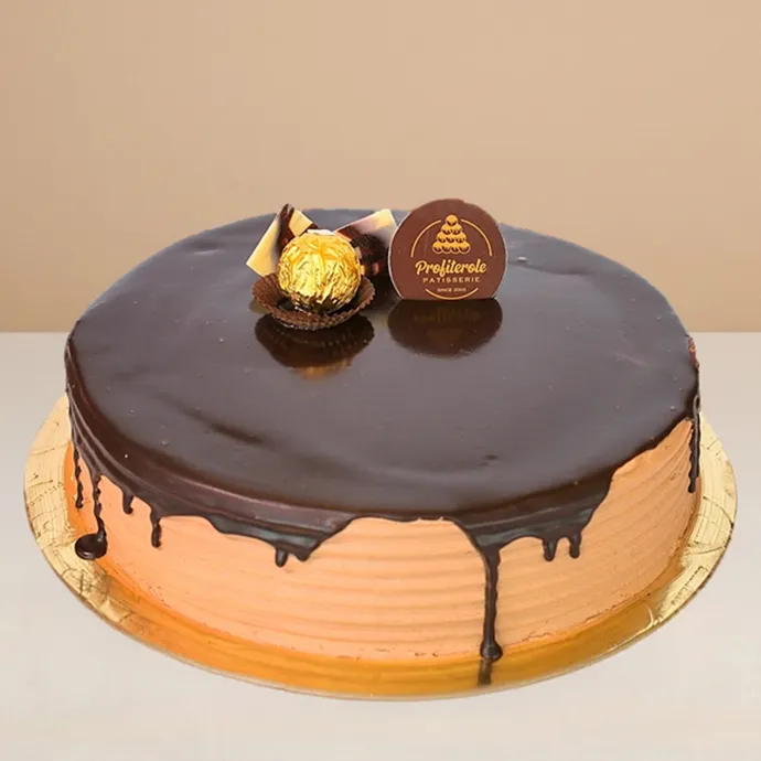 side view of the ferrero rocher cake with the chocolate ganache dripping downwards