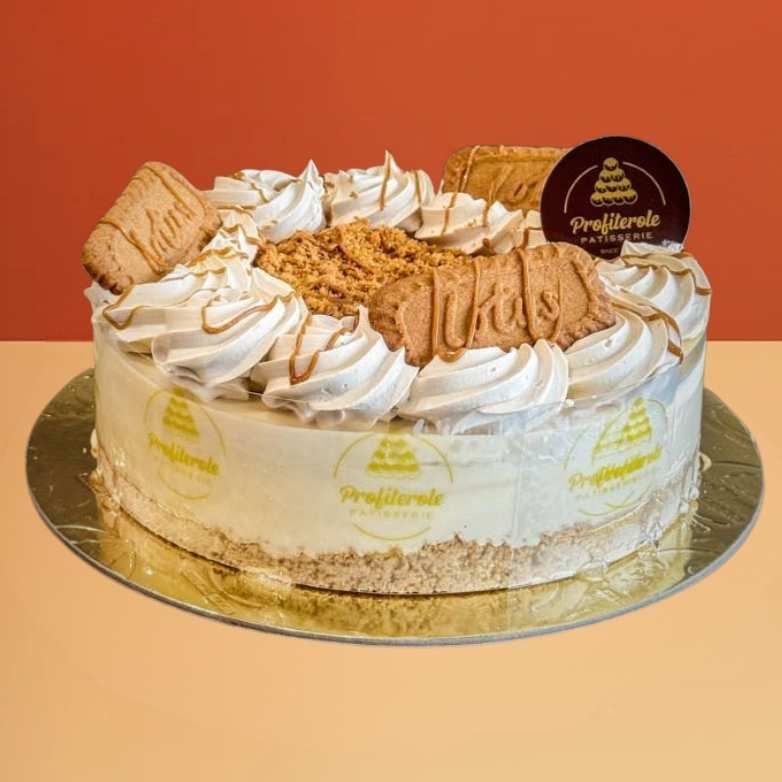 Lotus Biscoff cheesecake with cream piping, cookie crumble, and caramel drizzle