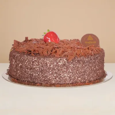 side view of black forest cake covered in chocolate shavings