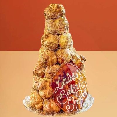 Caramel croquembouche tower with spun toffee and a personalised baby shower plaque